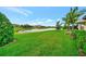 Expansive backyard with lush green grass and a tranquil pond, offering serene views at 10213 Saint Francis Ter, Palmetto, FL 34221