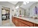 A stunning bathroom featuring a granite countertop vanity with a view into a walk-in closet at 10213 Saint Francis Ter, Palmetto, FL 34221