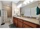Bright bathroom with a large vanity and granite countertop and a shower and tub combo at 10213 Saint Francis Ter, Palmetto, FL 34221