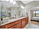 Modern bathroom showcasing double sinks and vanity with granite countertops next to a separate shower at 10213 Saint Francis Ter, Palmetto, FL 34221