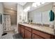 Bathroom featuring double vanity with granite countertops and tiled shower-tub combo at 10213 Saint Francis Ter, Palmetto, FL 34221