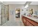 A stunning bathroom with a glass shower and vanity with granite countertops and ample cabinet space at 10213 Saint Francis Ter, Palmetto, FL 34221