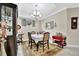 Traditional dining room with elegant chandelier, serving cart, and neutral color palette at 10213 Saint Francis Ter, Palmetto, FL 34221