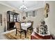 Bright dining area with a floral rug, china cabinet, and window at 10213 Saint Francis Ter, Palmetto, FL 34221