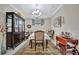 Dining room with a china cabinet, chandelier, and rectangular table at 10213 Saint Francis Ter, Palmetto, FL 34221