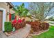 A beautifully landscaped walkway with a vibrant array of colorful plants and brick edging at 10213 Saint Francis Ter, Palmetto, FL 34221