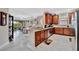 Spacious kitchen features granite counters, wooden cabinets, stainless appliances, and seamless flow to living at 10213 Saint Francis Ter, Palmetto, FL 34221