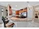 Open kitchen features granite countertops, stainless steel appliances, and breakfast bar seating at 10213 Saint Francis Ter, Palmetto, FL 34221