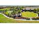 A view of the community lawn games area, perfect for outdoor activities and socializing near lush landscaping and walking path at 10213 Saint Francis Ter, Palmetto, FL 34221