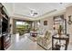 Elegant living room with tile floors, tray ceiling, and views of the outdoor area at 10213 Saint Francis Ter, Palmetto, FL 34221