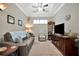 Relaxing living space with a ceiling fan, soft lighting, and patterned throw pillows at 10213 Saint Francis Ter, Palmetto, FL 34221