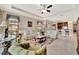 Open-plan living room with comfortable seating, neutral decor, and seamless flow to the kitchen at 10213 Saint Francis Ter, Palmetto, FL 34221