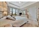 Bright main bedroom boasts a tray ceiling, large window, and plenty of natural light at 10213 Saint Francis Ter, Palmetto, FL 34221