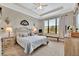 Serene main bedroom suite features a tray ceiling, large window, and neutral color scheme at 10213 Saint Francis Ter, Palmetto, FL 34221