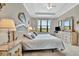 Spacious main bedroom features a large window, neutral tones, and ceiling fan at 10213 Saint Francis Ter, Palmetto, FL 34221