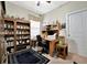Office space with ceiling fan, desk, shelving, and view to bathroom at 10213 Saint Francis Ter, Palmetto, FL 34221