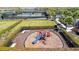 A delightful community playground with slide and climbing features is encased by a hedge and backs to the community tennis courts at 10213 Saint Francis Ter, Palmetto, FL 34221