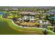 Aerial view of a spacious community pool area with lush landscaping, multiple pools, and plenty of seating and palm trees at 10213 Saint Francis Ter, Palmetto, FL 34221