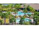 A refreshing community pool area featuring tropical landscaping, sun loungers, and a variety of seating for relaxing by the pool at 10213 Saint Francis Ter, Palmetto, FL 34221