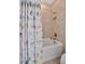 Bathroom shower-tub combo featuring a decorative shower curtain and tiled walls at 10213 Saint Francis Ter, Palmetto, FL 34221