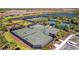 Overhead view of tennis courts and surrounding residential community, perfect for active residents at 10213 Saint Francis Ter, Palmetto, FL 34221