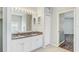Bathroom features double sinks with granite counters and vanity lighting, with tiled floor at 10810 Moss Island Dr, Riverview, FL 33569