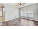 Inviting bedroom with wood flooring, a large window, and soft, neutral paint at 10810 Moss Island Dr, Riverview, FL 33569