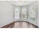 Bedroom with three windows, hardwood floors, and a ceiling fan with lots of natural light at 10810 Moss Island Dr, Riverview, FL 33569