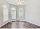 Bedroom with a ceiling fan, hardwood floors, three windows, and lots of natural light at 10810 Moss Island Dr, Riverview, FL 33569