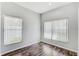 Bright bedroom features laminate flooring and plenty of natural light from two large windows at 10810 Moss Island Dr, Riverview, FL 33569