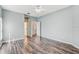 Well-lit bedroom features ceiling fan, laminate flooring and is painted a serene light blue color at 10810 Moss Island Dr, Riverview, FL 33569