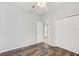 Bedroom featuring hardwood floors, a closet and access to the main hall at 10810 Moss Island Dr, Riverview, FL 33569