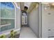 Property entrance featuring a gray exterior with white trim and an arched glass door at 10810 Moss Island Dr, Riverview, FL 33569