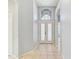 Light and bright foyer with a tiled floor, white walls, and a beautiful glass front door at 10810 Moss Island Dr, Riverview, FL 33569