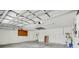 Spacious garage with high ceilings, a utility sink, and plenty of room for storage and projects at 10810 Moss Island Dr, Riverview, FL 33569