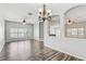 Open-concept living space with wood floors, built-in shelves, and views to the kitchen at 10810 Moss Island Dr, Riverview, FL 33569