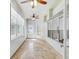 Bright sunroom with tile flooring, large windows, and multiple ceiling fans for added comfort at 10810 Moss Island Dr, Riverview, FL 33569