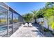 Serene pool deck featuring lounge chairs, lush greenery, and a screened-in enclosure for ultimate relaxation at 1116 Jacob Way, Odessa, FL 33556