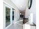 Bright hallway with tile flooring, leading to various rooms, enhanced by natural light and elegant wall decor at 11817 Blackeyed Susan Dr, Riverview, FL 33579