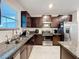 Kitchen featuring granite countertops, stainless steel appliances, and modern fixtures at 11817 Blackeyed Susan Dr, Riverview, FL 33579