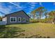 A spacious backyard with a well-maintained lawn, ideal for outdoor activities and relaxation at 122 Jennifer Dr, Rotonda West, FL 33947
