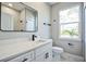 This modern bathroom features a white vanity with a stylish black faucet, complementing the marble-look tiles at 122 Jennifer Dr, Rotonda West, FL 33947