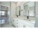 Modern bathroom featuring a double sink vanity with white cabinets, quartz countertop and black hardware at 122 Jennifer Dr, Rotonda West, FL 33947