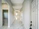 Long hallway features ceramic tile flooring leading to a bedroom and a living area at 122 Jennifer Dr, Rotonda West, FL 33947