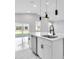 Close-up of a stylish kitchen island with a stainless steel dishwasher and a modern faucet at 122 Jennifer Dr, Rotonda West, FL 33947