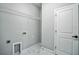 Functional laundry room features a wire shelf, a utility sink, and a white door at 122 Jennifer Dr, Rotonda West, FL 33947