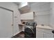 Well-lit laundry room featuring a modern washer and dryer and built in shelves at 12523 River Birch Dr, Riverview, FL 33569