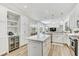 Open kitchen with stone countertops, stainless steel appliances, and integrated wine cooler at 14820 Bowfin Ter, Lakewood Ranch, FL 34202