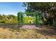 Picturesque backyard scene with a charming pergola and view of the serene pond, perfect for peaceful outdoor enjoyment at 1730 W Del Webb Blvd, Sun City Center, FL 33573