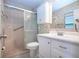 This bathroom features a tiled shower, toilet, white vanity, and white medicine cabinet at 1730 W Del Webb Blvd, Sun City Center, FL 33573